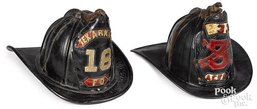 TWO PAINTED LEATHER FIRE HELMETS,