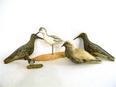 Two painted wooden birds on st