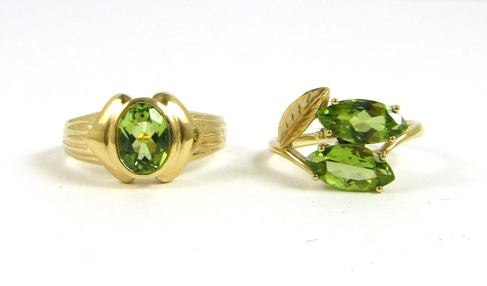 TWO PERIDOT AND FOURTEEN KARAT GOLD