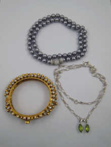 Two peridot pendants set in white
