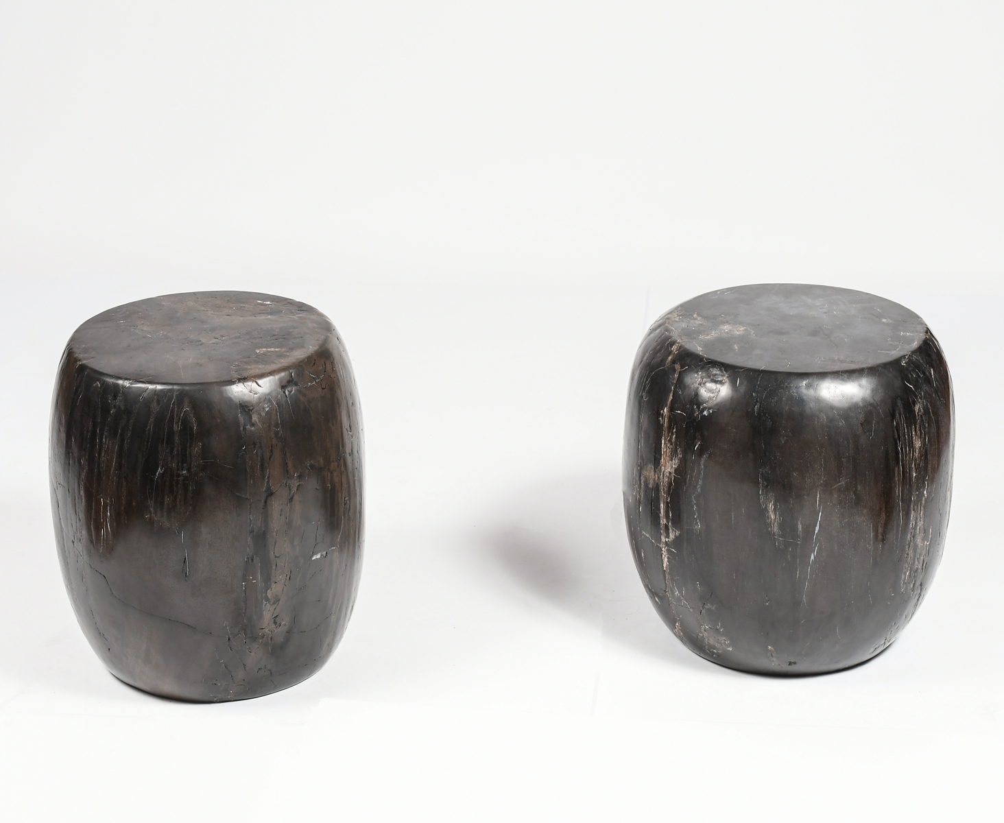 TWO PETRIFIED WOOD STOOLS /