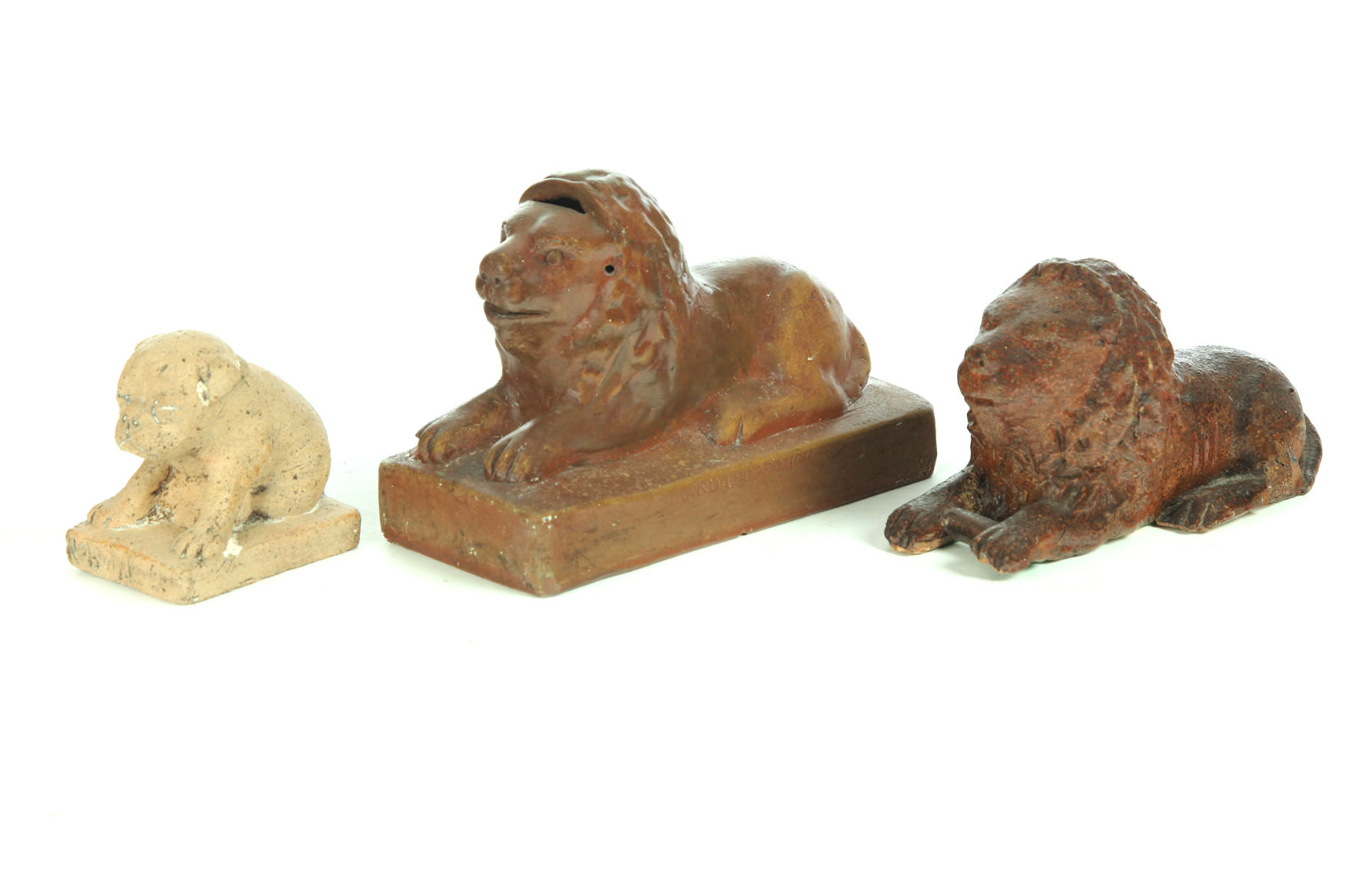 TWO POTTERY LIONS AND A DOG. 