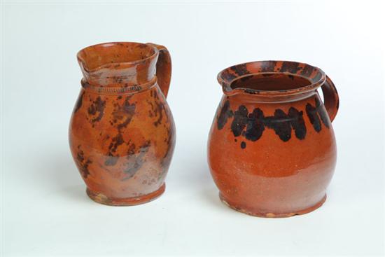 TWO REDWARE PITCHERS.  American 