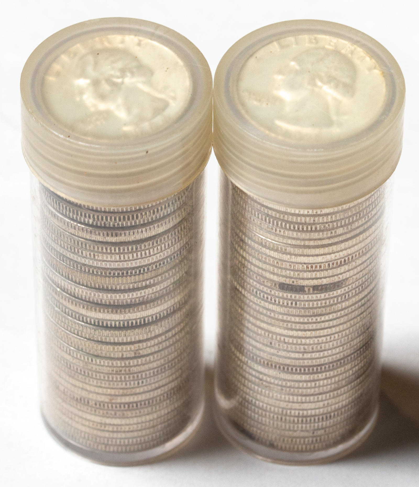 TWO ROLLS OF SILVER QUARTERS 1964s.