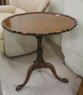 TWO ROUND MAHOGANY TILT-TOP TE
