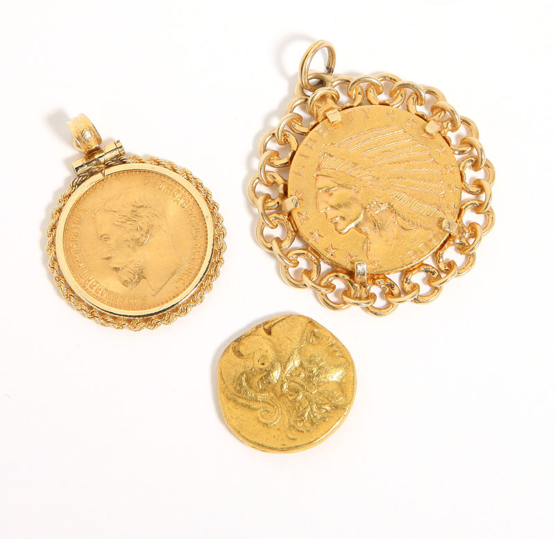 Two set in gold bezel pendants;
