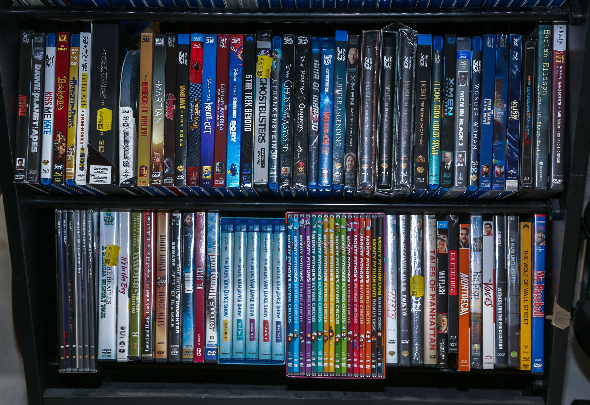 TWO SHELVES OF ASSORTED DVDS &