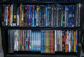 TWO SHELVES OF ASSORTED DVDS &