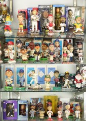 TWO SHELVES OF BOBBLE HEADS IN