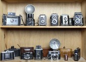 TWO SHELVES OF CAMERAS AND LEN