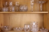 TWO SHELVES OF CUT GLASS DECOR