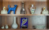 TWO SHELVES OF DECORATIVE ARTS