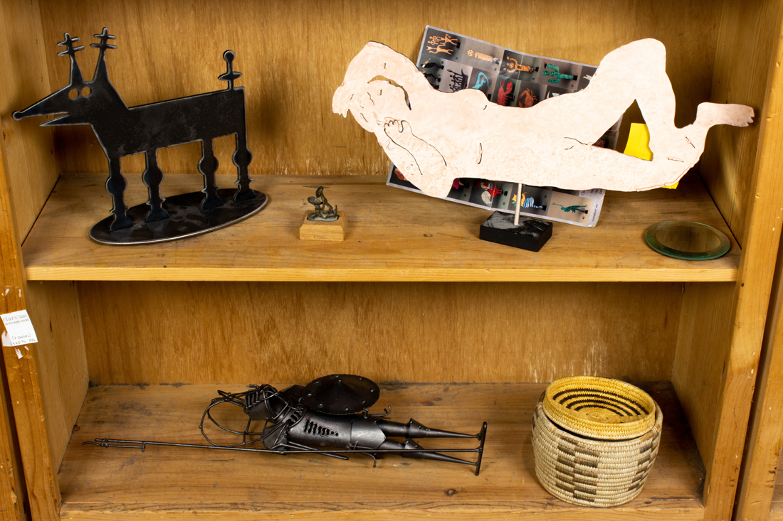 TWO SHELVES OF METAL SCULPTURES
