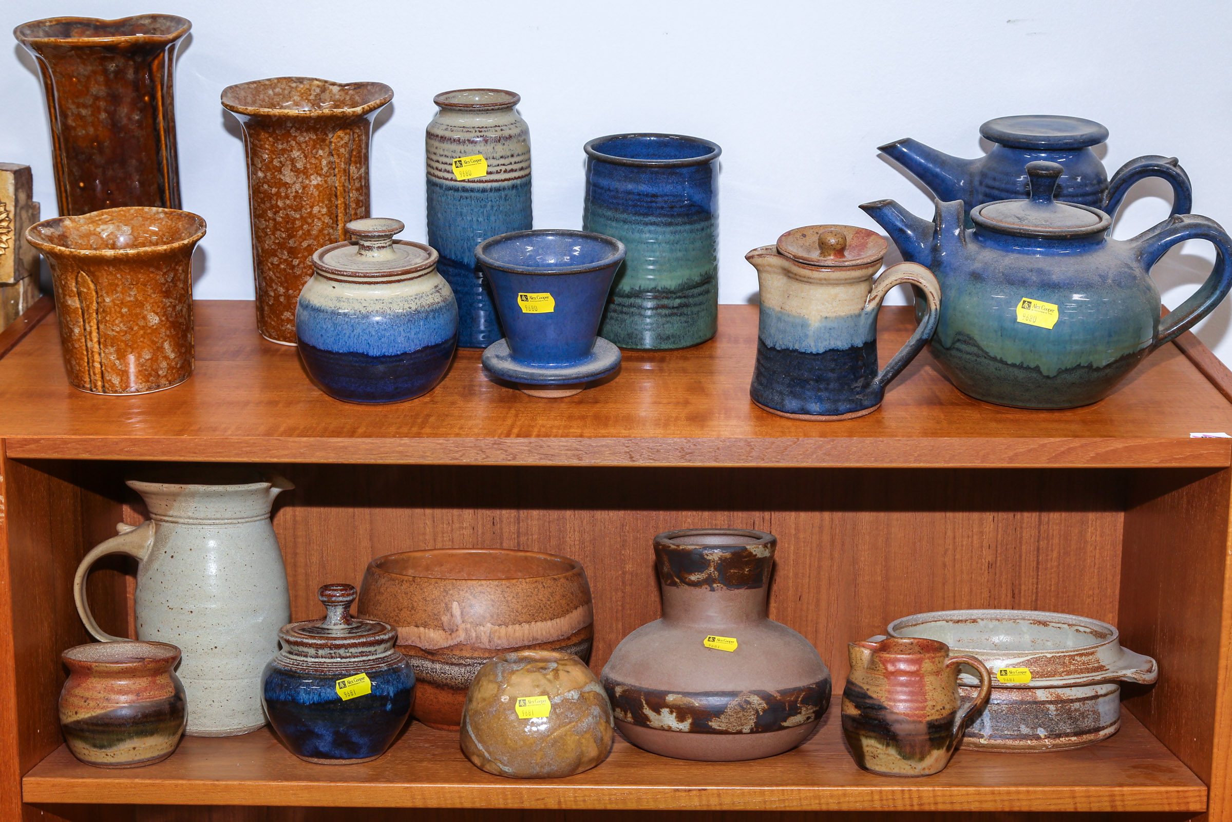TWO SHELVES OF MODERN ART POTTERY .