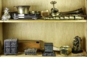 TWO SHELVES OF MOSTLY BRASS DE