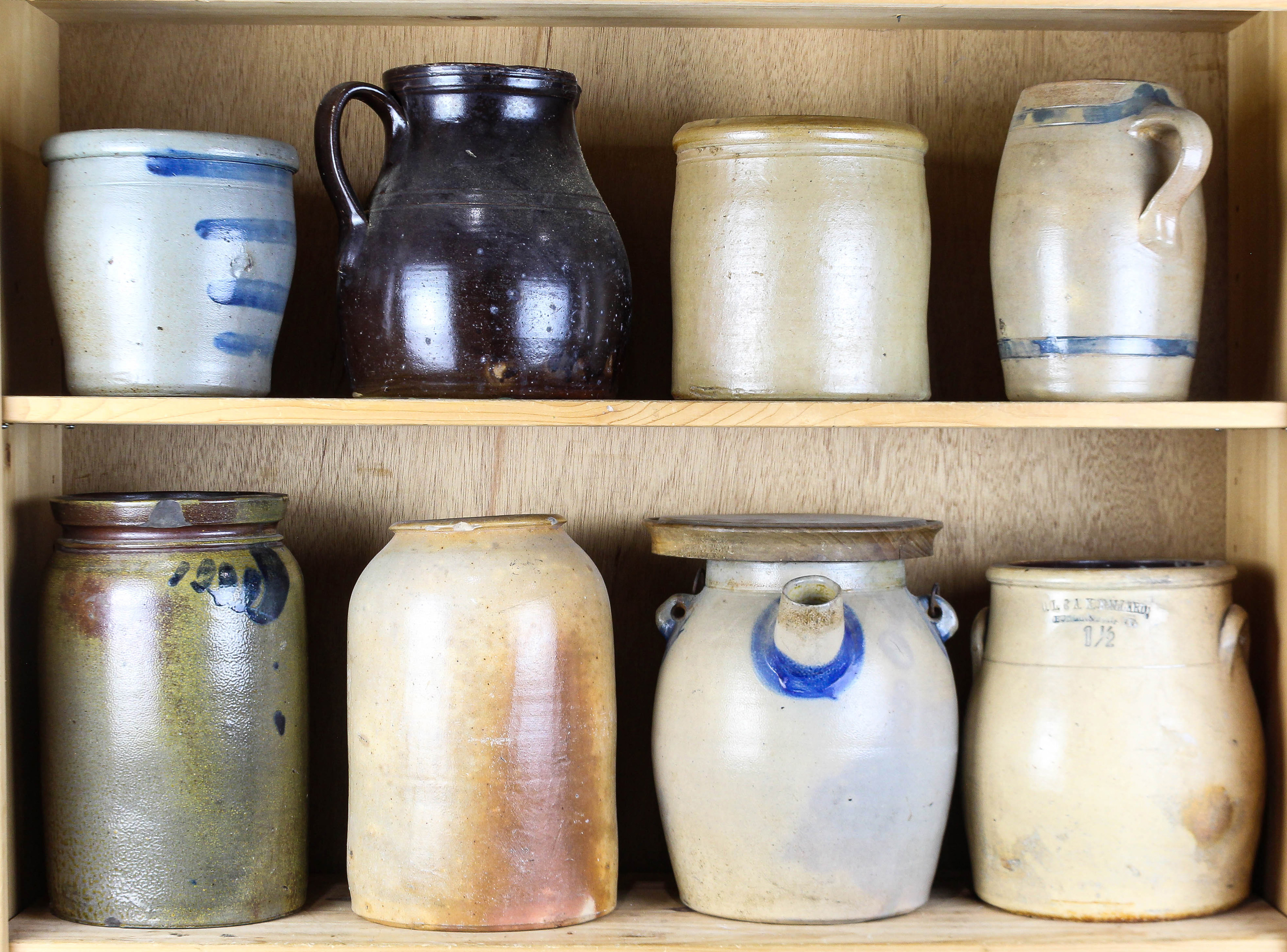 TWO SHELVES OF STONEWARE CROCKS AND