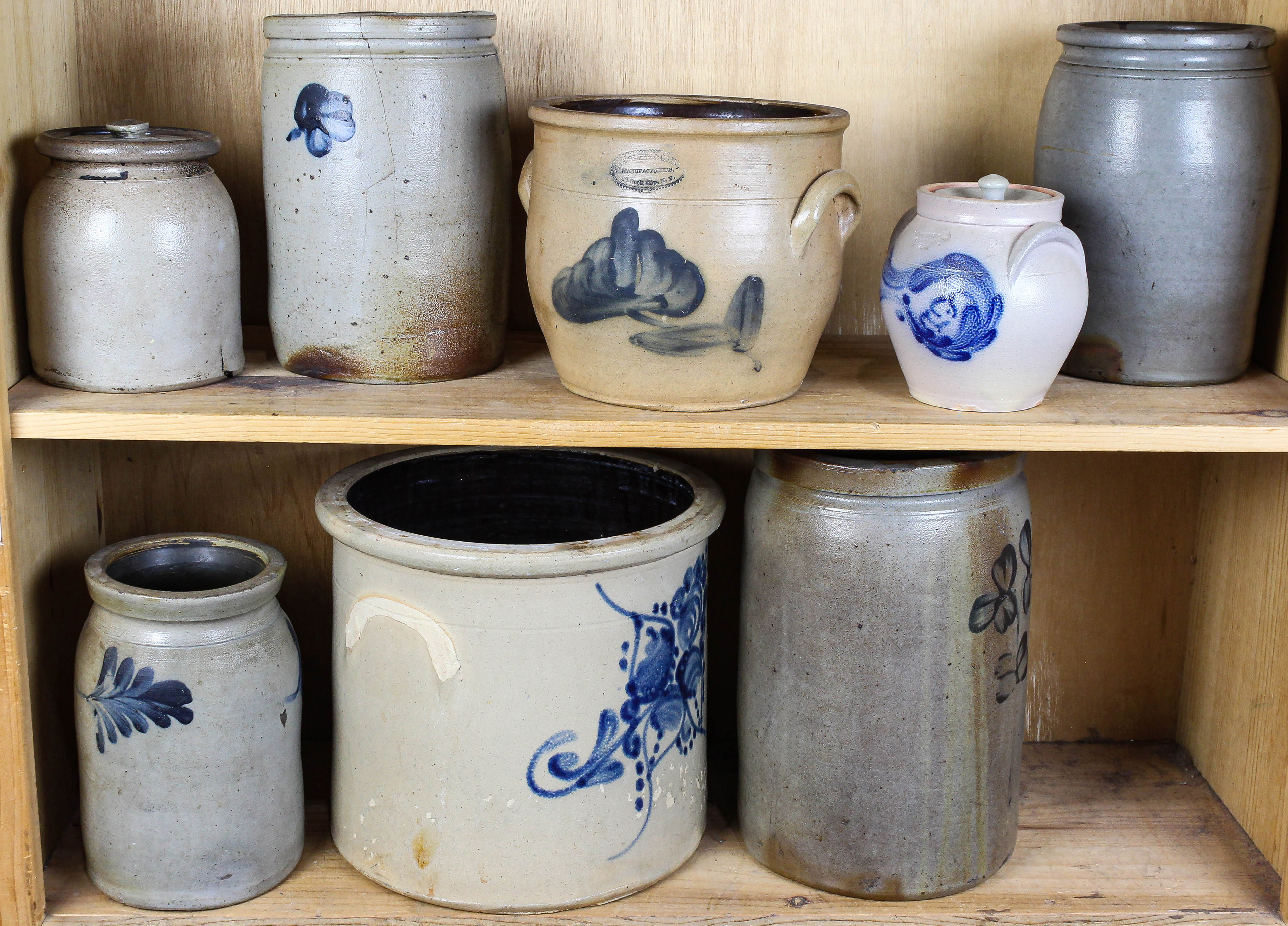 TWO SHELVES OF STONEWARE CROCKS AND