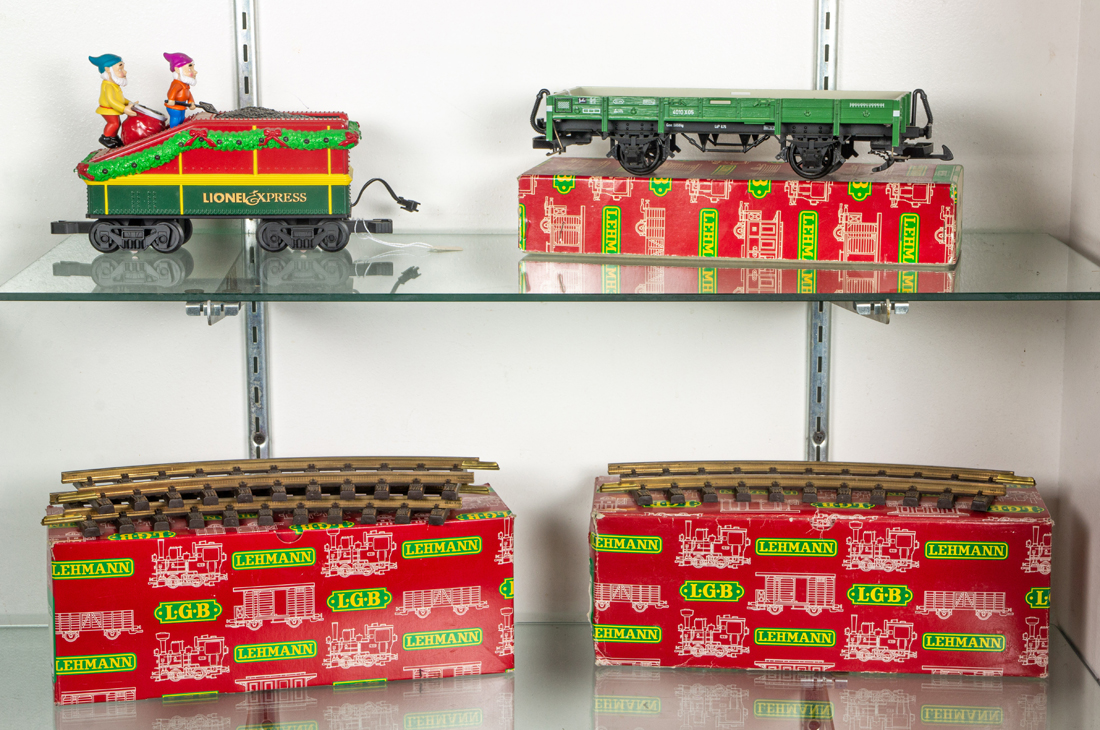 TWO SHELVES OF TOY TRAINS AND
