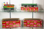 TWO SHELVES OF TOY TRAINS AND