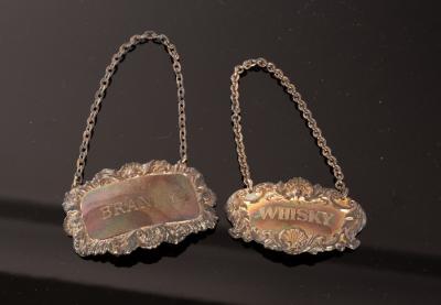 Two silver decanter labels,
