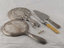 Two silver hand mirrors a silver