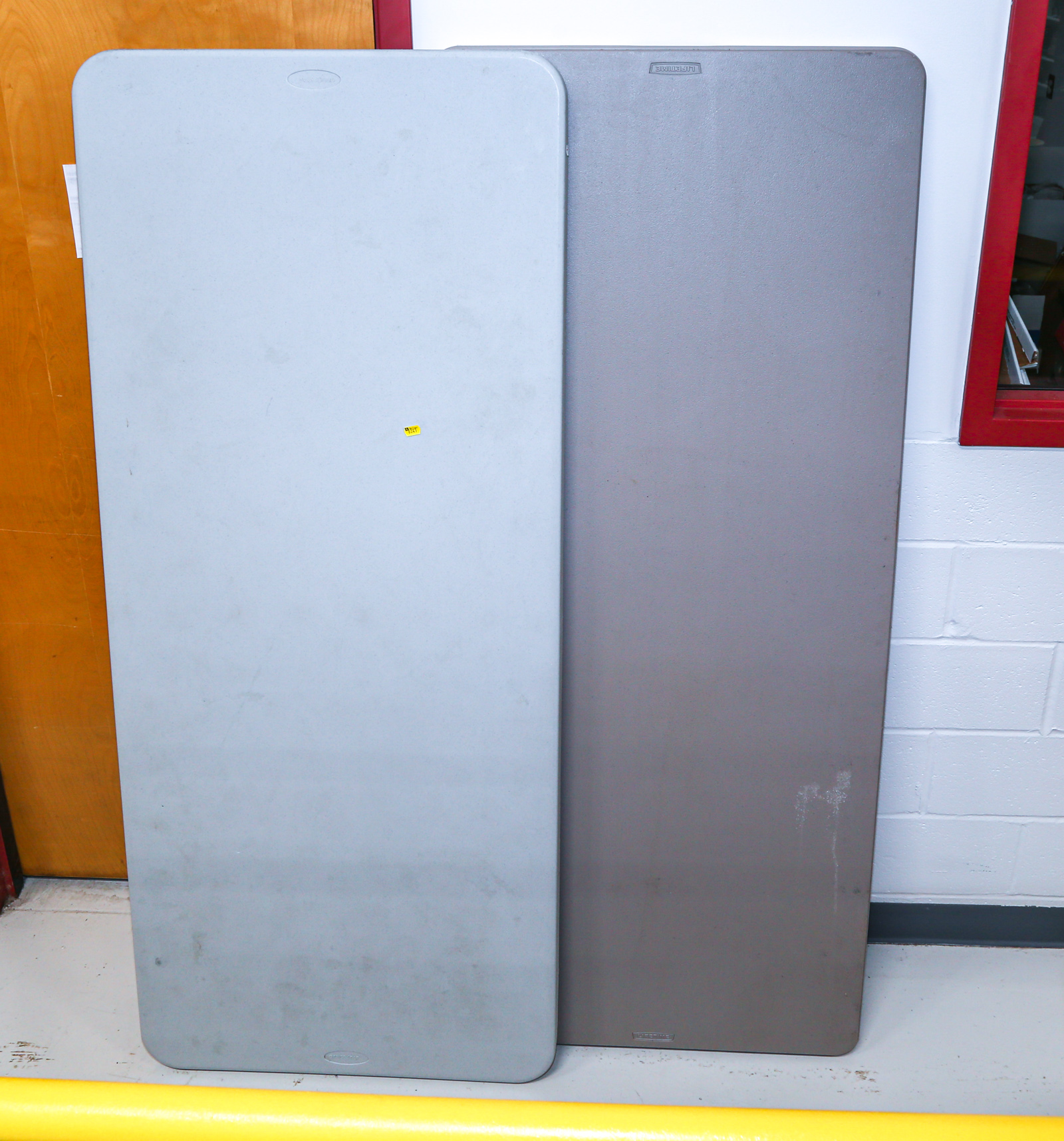 TWO SIX FOOT PLASTIC FOLDING TABLES