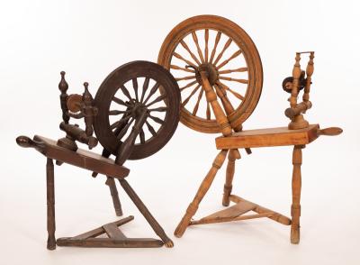 Two spinning wheels, the largest