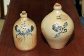 TWO STONEWARE JUGS. A floral c