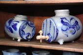 TWO STONEWARE KEGS. Tri-footed