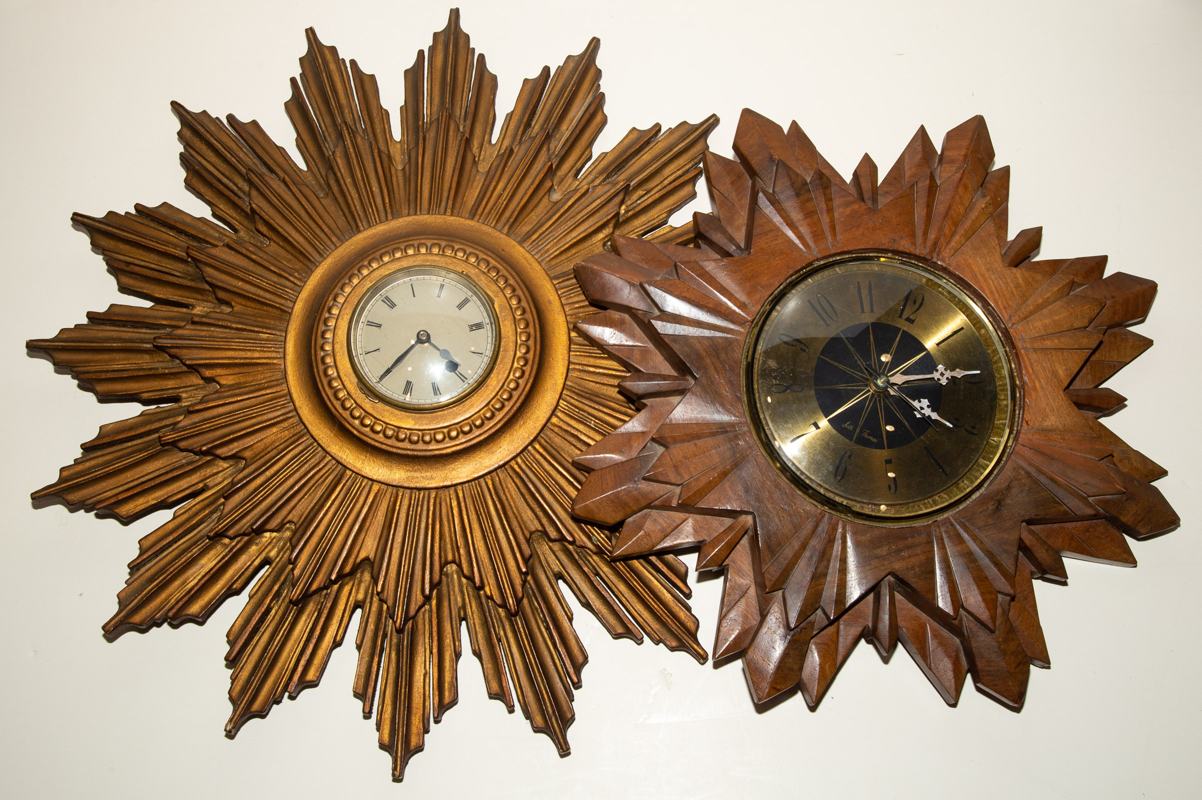 TWO SUNBURST WALL CLOCKS Seth