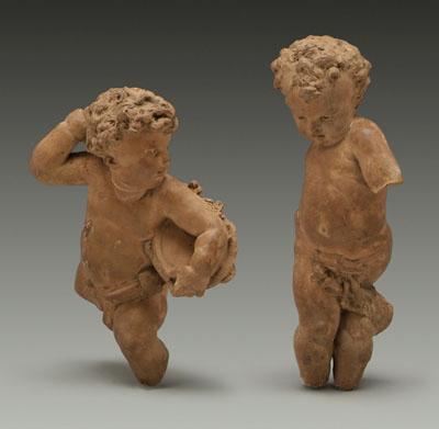 Two terra cotta putti : one holding