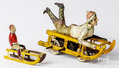TWO TIN LITHOGRAPH BOY ON SLED