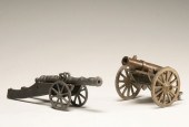 Two toy cannons; brass field a
