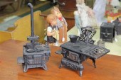 TWO TOY STOVES. Both are cast