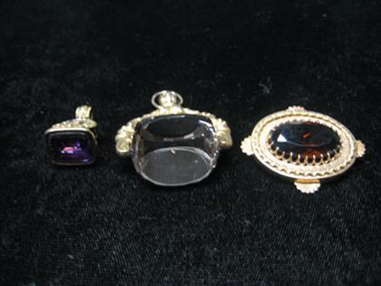 Two watch fobs and one small brooch