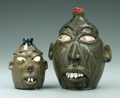 Two Wayne Hewell face jugs: both