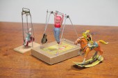 TWO WIND-UP TOYS AND A TIN SWI