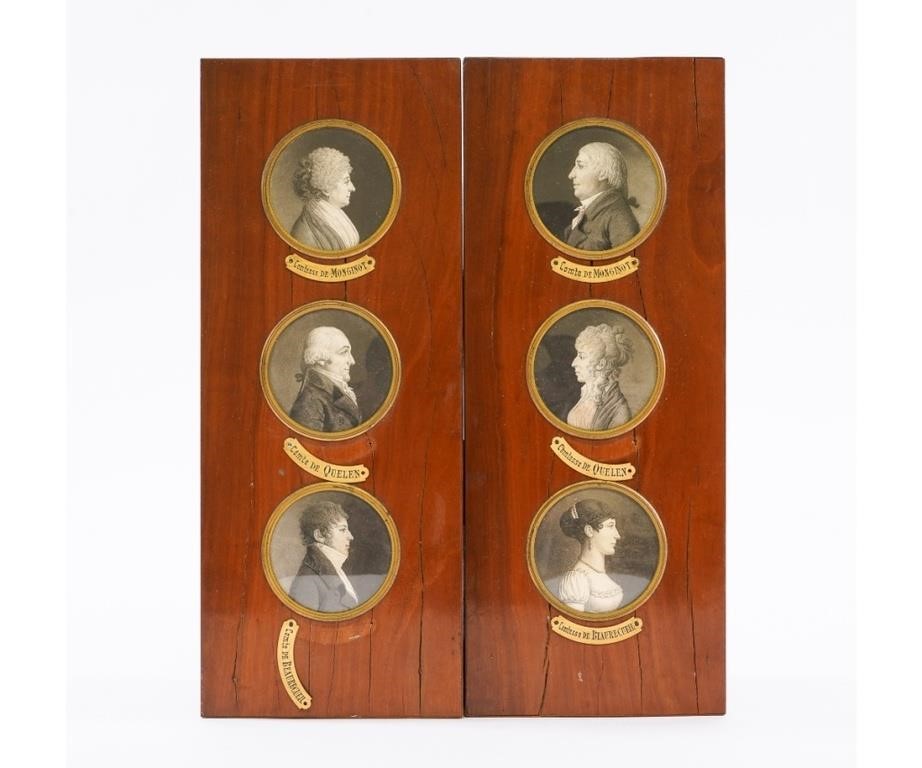 Two wood panels each set with three