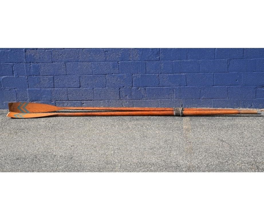 Two wooden sweeps (oars),