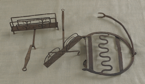 Two wrought iron toast racks