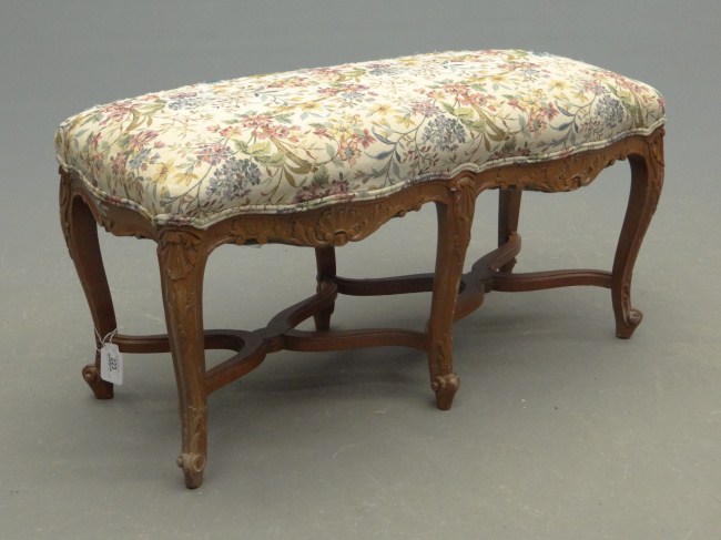 Upholstered bench with carved