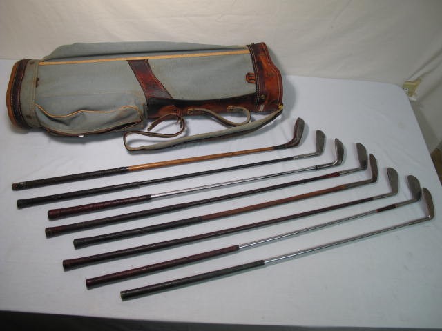 Vintage golf bag & 8 golf clubs.