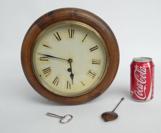 Wall clock with key and pendulum.