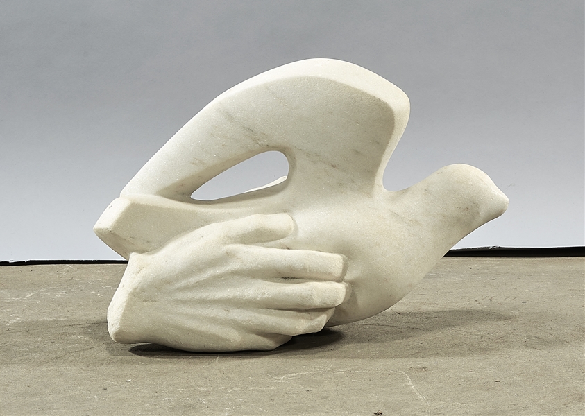 White marble sculpture of a hand