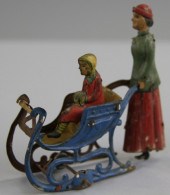 WOMAN PUSHING CHILD IN SLEIGH