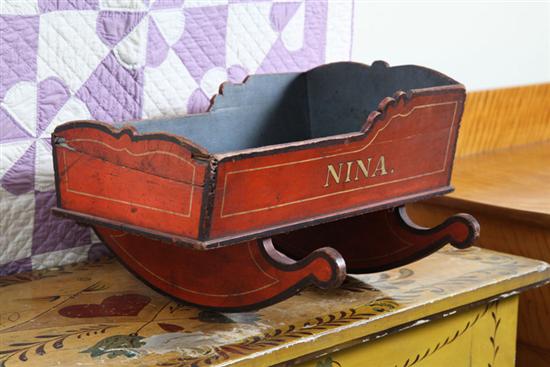WOOD DOLL CRADLE. Black and red