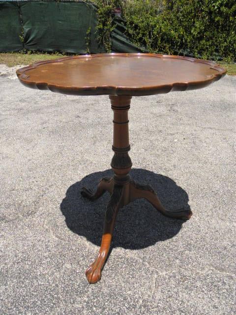 Wooden tilt-top pie crust table.