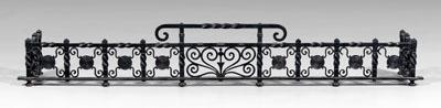 Wrought iron fender, cast and
