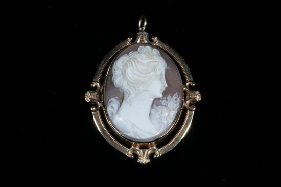 YELLOW GOLD FRAMED OVAL CARVED