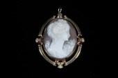 YELLOW GOLD FRAMED OVAL CARVED